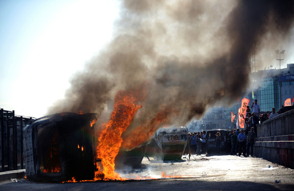 A police car burned in Taksim Square in Istanbul. Photo by Bulent Kilic/Agence France-Presse — Getty Images
